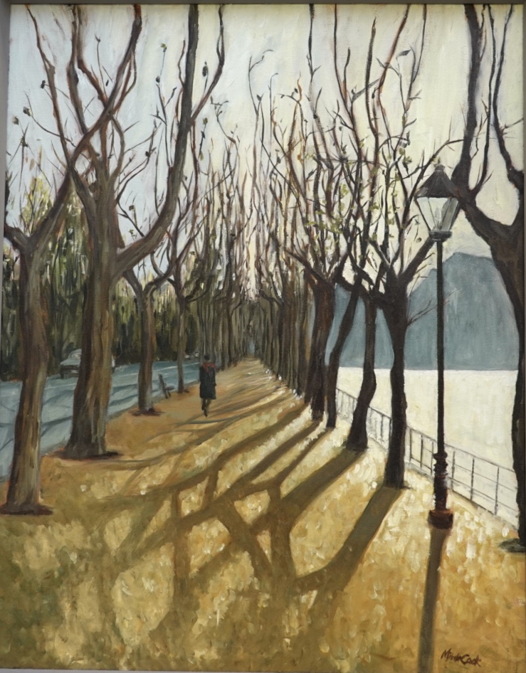 An oil painting depicting a tree lined sidewalk with a pedestrian at the shore of Lake Como with the winter light glowing over the distant mountain.